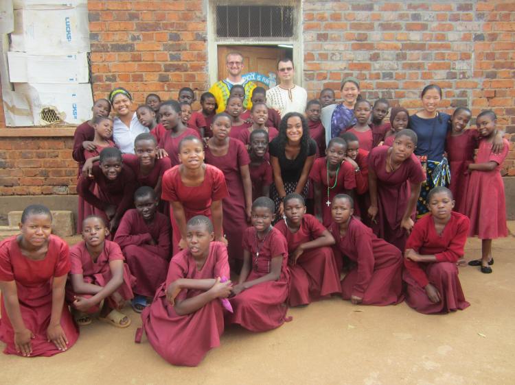The group of SMU students pose with the students at the primary school. 